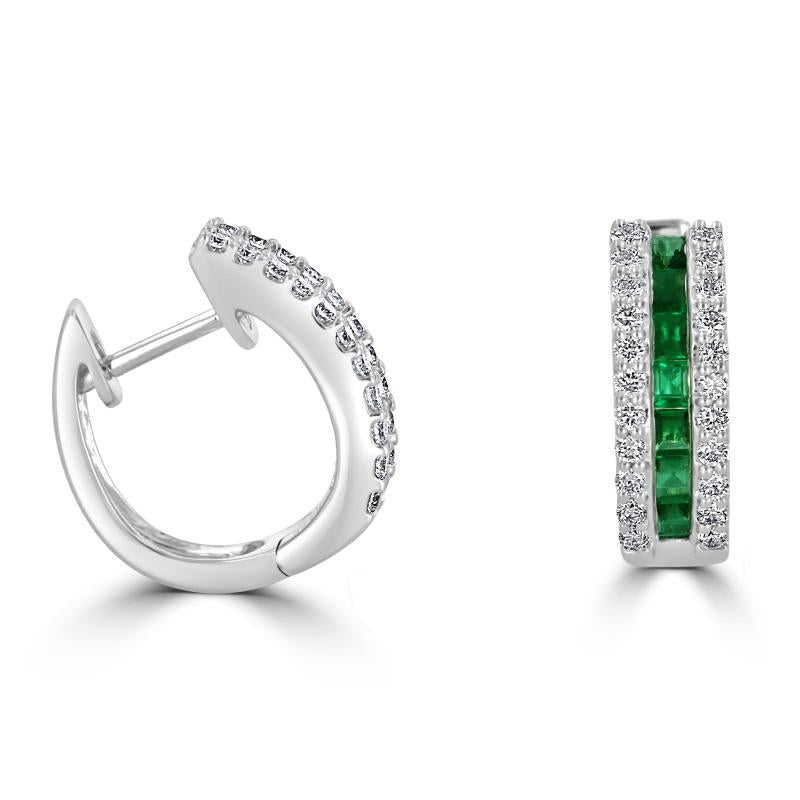 Close-up of 14K white gold huggie earrings featuring square-cut emeralds flanked by pavé-set round diamonds, luxury fine jewelry for women.

