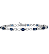 oval sapphire and round diamond tennis bracelet in 14K white gold, perfect for elegant occasions

