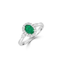 14K gold oval emerald halo ring with two round side diamonds

