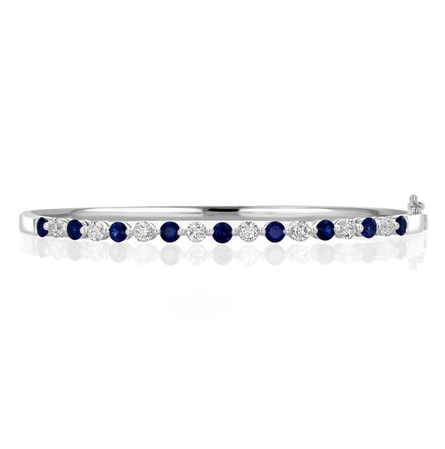 Luxury 14K gold bangle bracelet with alternating round sapphires and diamonds in shared prong setting