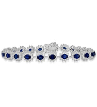 Elegant oval sapphire and diamond halo tennis bracelet in white gold