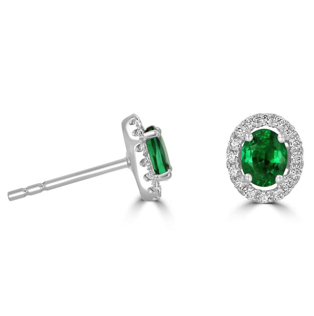 Pair of oval emerald halo earrings surrounded by round diamonds in white gold