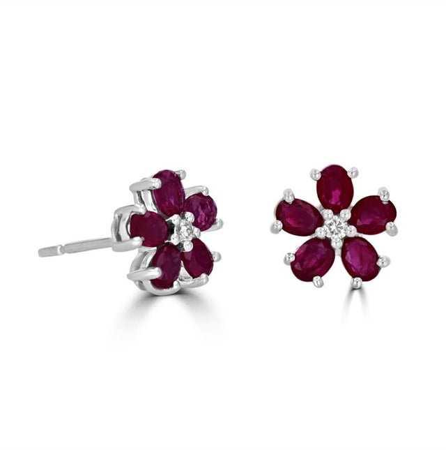 14K white gold floral stud earrings with oval rubies and round diamonds in a flower petal design
