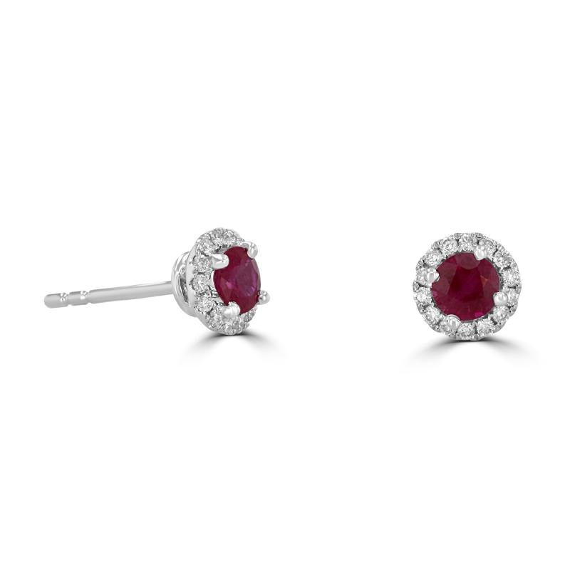 Close-up of 14K white gold round ruby and diamond halo stud earrings with secure post back.