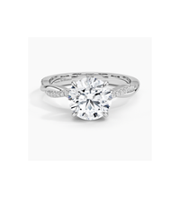 14K white gold engagement ring with infinity twist pavé band and round-cut lab-grown diamond. Elegant and timeless bridal jewelry.