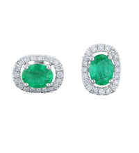 Pair of 14K gold oval emerald earrings with diamond halo

