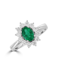 oval emerald ring surrounded by round diamonds in a 14K white gold halo setting