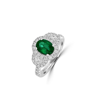 Luxury oval emerald and diamond halo ring set in 14K white gold, featuring brilliant-cut diamonds on a polished band.

