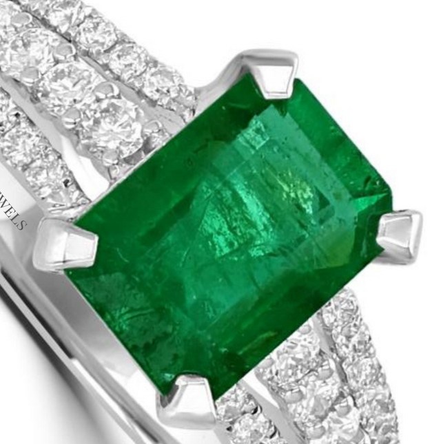 14K white gold ring featuring emerald-cut emerald with three rows of round diamonds on shank

