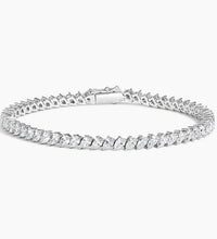 A stunning 14K gold diamond tennis bracelet featuring pavé-set teardrop diamonds, available in white, yellow, or rose gold. Luxury fine jewelry for women.

