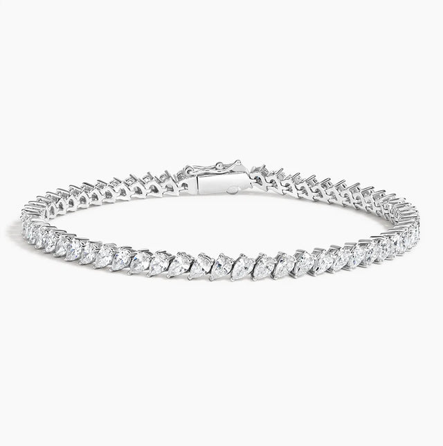 A stunning 14K gold diamond tennis bracelet featuring pavé-set teardrop diamonds, available in white, yellow, or rose gold. Luxury fine jewelry for women.

