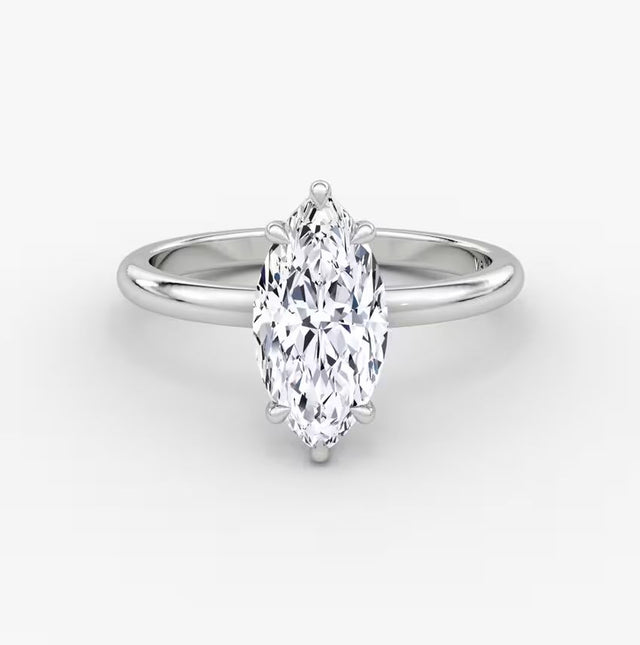 Elegant marquise diamond ring in 14K gold with pavé-set halo and cluster side accents, available in yellow, white, rose gold, or platinum.

